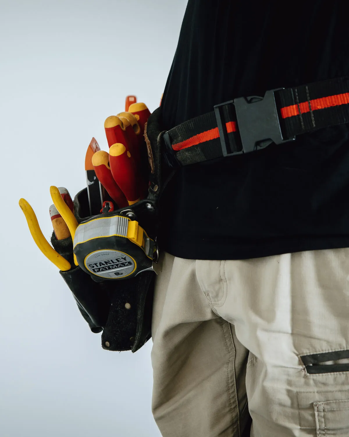 Professional electrician with tools ready to help