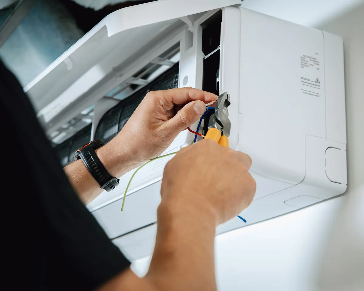 Technician installing heat pump unit